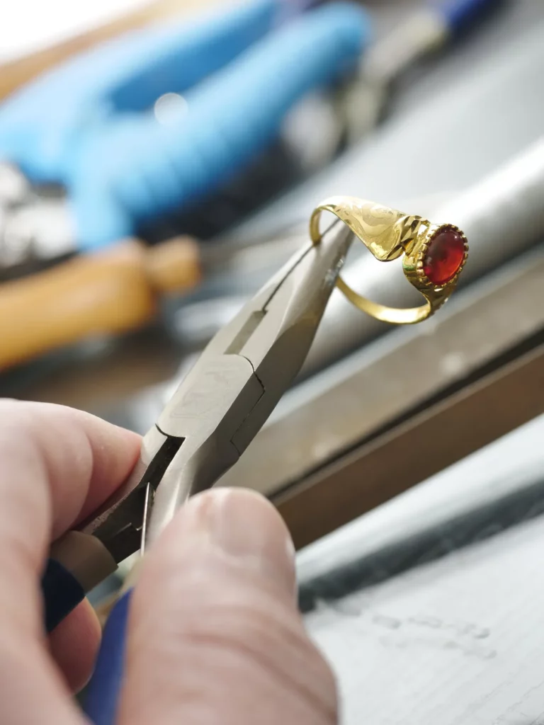 jeweler repairing a gold ring
