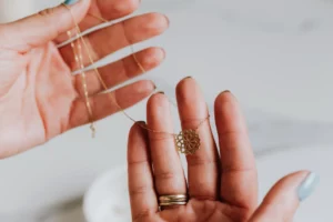 picture of 2 hands holding jewellery necklaces