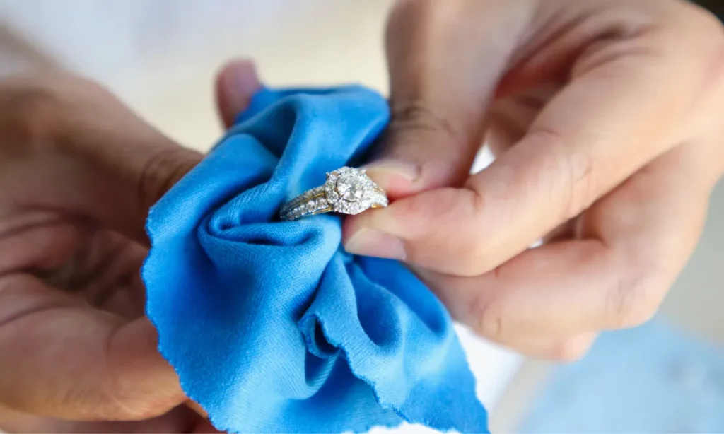  holding a gold ring wrapped in blue cloth